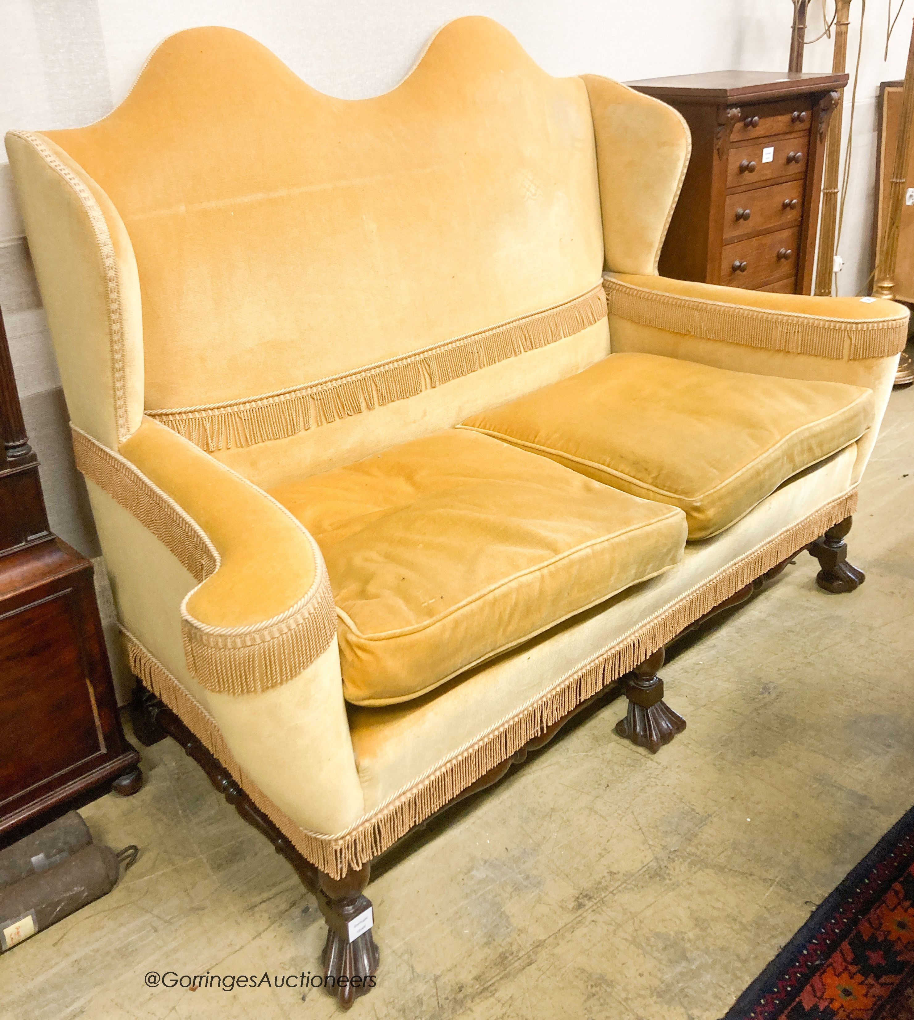 A William and Mary style upholstered wingback settee, length 165cm, depth 75cm, height 121cm